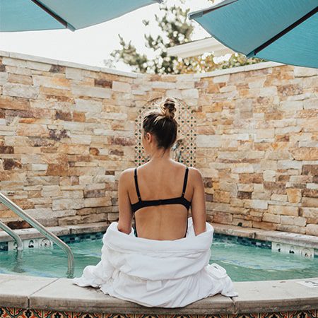 woman sitting on the edge of our hot tub